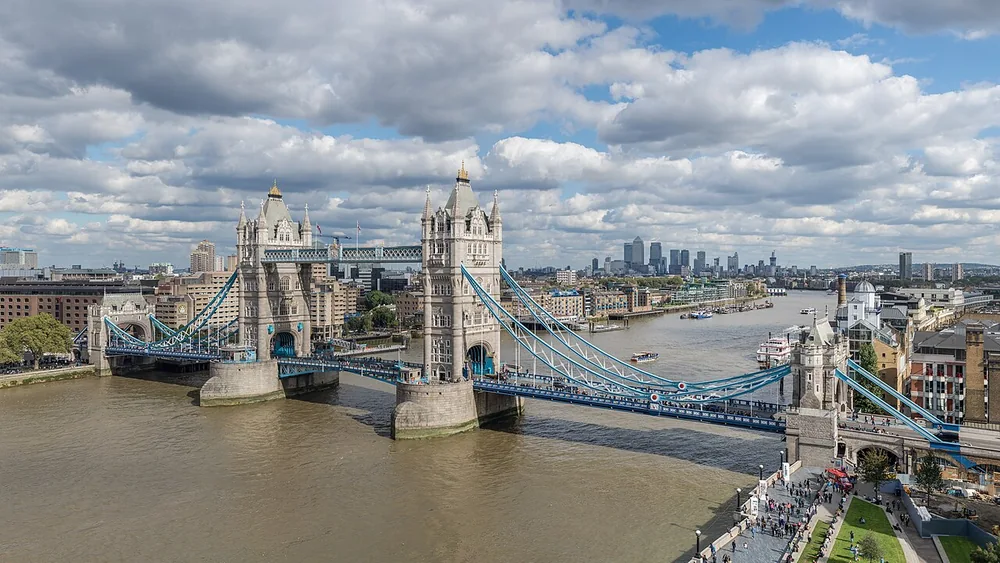 Tower Bridge spanning the Thames, with both stone towers and blue suspension elements visible.